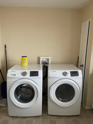 a washing machine and a washer in a room at MT Pleasant NW 2 bedrooms 502 in Calgary