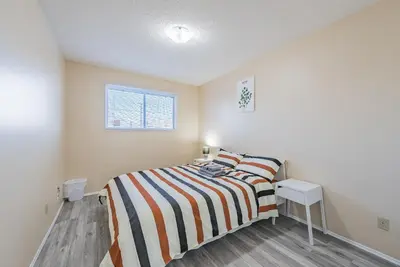 a small bedroom with a bed and a window at MT Pleasant NW 2 bedrooms 502 in Calgary