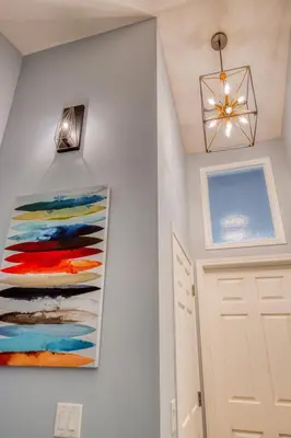 a hallway with a painting on the wall next to a door at Beautiful Newly Reno 2BDM 2 Bth Sleep up to 6 Adults & Kids Mountain View Townhouse Suite in Canmore