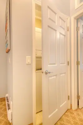 a door leading to a closet in a room at Beautiful Newly Reno 2BDM 2 Bth Sleep up to 6 Adults & Kids Mountain View Townhouse Suite in Canmore