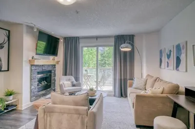 a living room with a couch and chairs and a fireplace at Cozy 2 BR - King and Queen Condo Sleep up to 6 for WFH & Vacation in Canmore