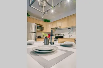 a kitchen with a table with plates on it at Cozy 2 BR - King and Queen Condo Sleep up to 6 for WFH & Vacation in Canmore