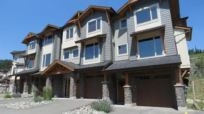 a large house with a garage at Echo Landing #22 by Bear Country in Sun Peaks