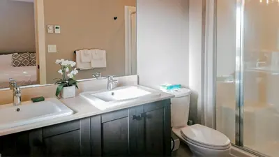 a bathroom with a sink and a toilet and a shower at Echo Landing #22 by Bear Country in Sun Peaks