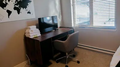 a room with a desk with a television and a chair at Echo Landing #22 by Bear Country in Sun Peaks