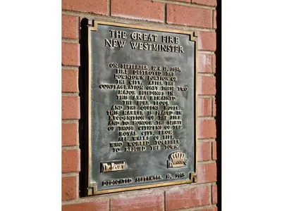 a plaque on the wall of a brick building at The Met Hotel in New Westminster
