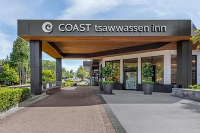 a building with a sign for a coast texas mansion at Coast Tsawwassen Inn in Delta