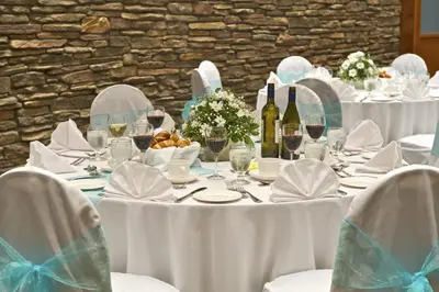 a table with white table cloths and wine bottles at Coast Tsawwassen Inn in Delta