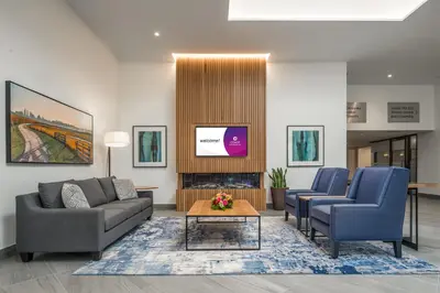 a living room with two couches and a fireplace at Coast Tsawwassen Inn in Delta