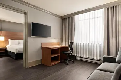 a hotel room with a bed and a desk at Days Inn by Wyndham Vancouver Downtown in Vancouver