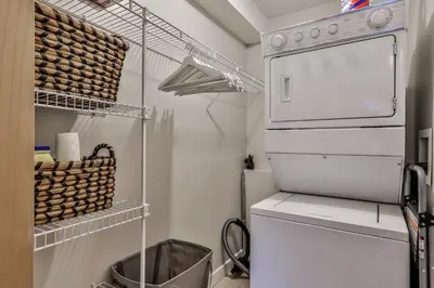 a small kitchen with a white stove and a refrigerator at CHARMING 1 Bdrm plus loft with VIEWS managed by Little Sister Getaways in Canmore