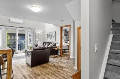 a living room with a couch and a table at CHARMING 1 Bdrm plus loft with VIEWS managed by Little Sister Getaways in Canmore