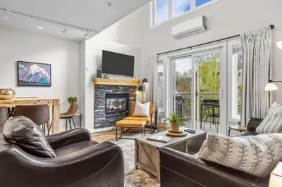 a living room with a couch and a fireplace at CHARMING 1 Bdrm plus loft with VIEWS managed by Little Sister Getaways in Canmore