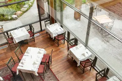 an overhead view of a restaurant with white tables and chairs at Moraine Lake Lodge in Lake Louise
