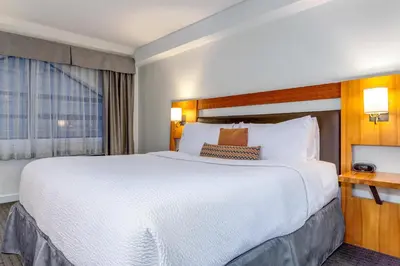 a hotel room with a large bed and a window at Listel Whistler, a Coast Hotel in Whistler