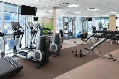 a gym with several treadmills and cardio machines at Hilton Vancouver Downtown, BC, Canada in Vancouver