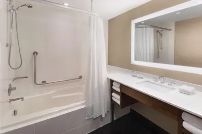 a bathroom with a tub and a sink and a shower at Hilton Vancouver Downtown, BC, Canada in Vancouver