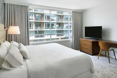 a hotel room with a bed and a large window at Hilton Vancouver Downtown, BC, Canada in Vancouver