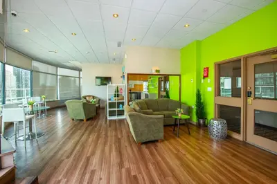 a living room with a couch and a green wall at Grand Park Hotel & Suites Downtown Vancouver, an Ascend Collection Hotel in Vancouver