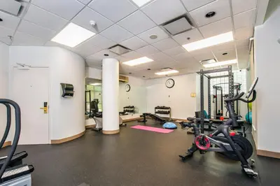 a gym with treadmills and exercise bikes in a room at Grand Park Hotel & Suites Downtown Vancouver, an Ascend Collection Hotel in Vancouver