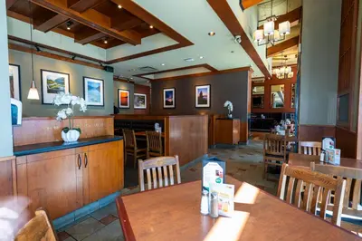 a dining room with tables and chairs and a restaurant at Grand Park Hotel & Suites Downtown Vancouver, an Ascend Collection Hotel in Vancouver