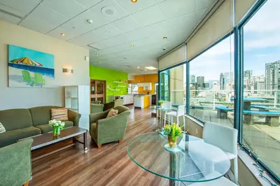 a living room with a couch and a glass table at Grand Park Hotel & Suites Downtown Vancouver, an Ascend Collection Hotel in Vancouver