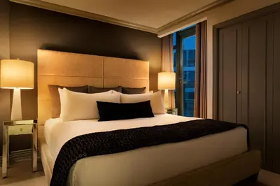 a bedroom with a large bed and a window at Hotel Le Soleil by Executive Hotels in Vancouver