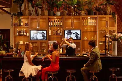 a group of people sitting at a bar at Hotel Le Soleil by Executive Hotels in Vancouver