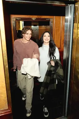 a man and a woman walking into an elevator at Hotel Le Soleil by Executive Hotels in Vancouver