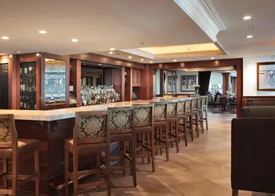 a bar with a row of chairs in a restaurant at The Sylvia Hotel in Vancouver