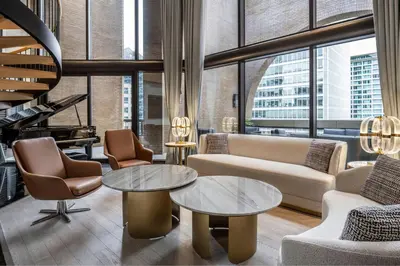 a living room with furniture and a large window at Metropolitan Hotel Vancouver in Vancouver