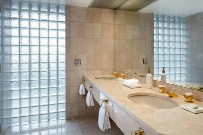 a bathroom with a sink and a large mirror at Metropolitan Hotel Vancouver in Vancouver