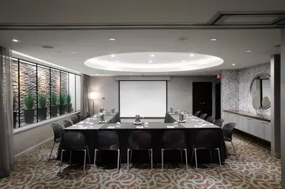 a meeting room with a long table and chairs at OPUS Vancouver in Vancouver