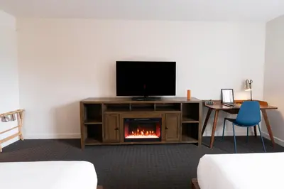 a living room with a tv and a fireplace at Adara Hotel in Whistler