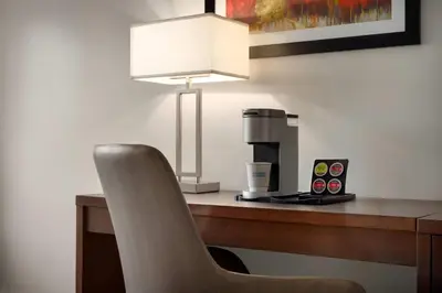 a desk with a chair and a coffee maker at La Quinta Inn by Wyndham Vancouver Airport in Richmond