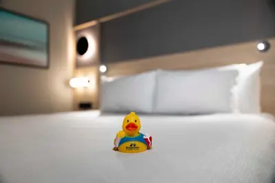 a rubber duck toy sitting on a bed at Accent Inns Vancouver Airport in Richmond