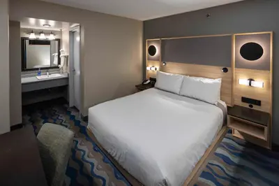 a hotel room with a bed and a sink at Accent Inns Vancouver Airport in Richmond