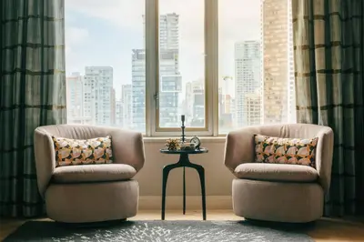 two chairs and a table in a room with a window at Delta Hotels by Marriott Vancouver Downtown Suites in Vancouver