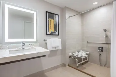 a bathroom with a sink and a shower at Delta Hotels by Marriott Vancouver Downtown Suites in Vancouver