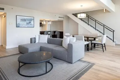 a living room with a couch and a table at Delta Hotels by Marriott Victoria Ocean Pointe Resort in Victoria
