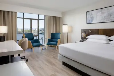 a hotel room with a bed and two chairs at Delta Hotels by Marriott Victoria Ocean Pointe Resort in Victoria