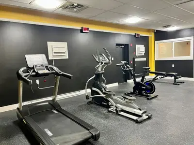 a gym with three exercise bikes in a room at The Vic, an Ascend Collection Hotel in Victoria