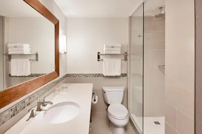 a bathroom with a toilet and a sink and a mirror at The Westin Bayshore, Vancouver in Vancouver