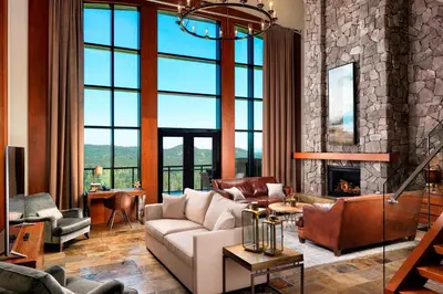 a living room with a couch and a fireplace at The Westin Bear Mountain Resort & Spa, Victoria in Victoria