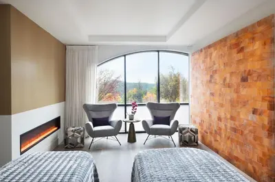 two beds in a room with a brick wall at The Westin Bear Mountain Resort & Spa, Victoria in Victoria