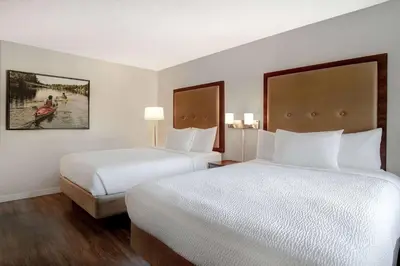 a hotel room with two beds and two lamps at Days Inn by Wyndham Victoria Uptown in Victoria