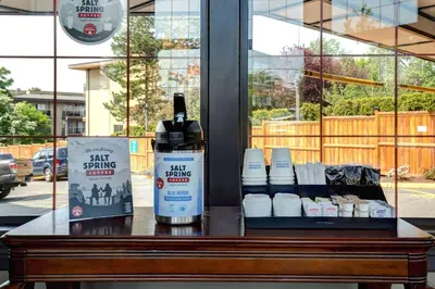 a table with a bottle of paint sitting on it at Days Inn by Wyndham Victoria Uptown in Victoria