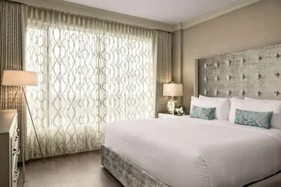 a bedroom with a large bed and a large window at Georgian Court Hotel, WorldHotels Elite in Vancouver