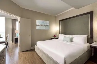 a bedroom with a large bed with a large headboard at Georgian Court Hotel, WorldHotels Elite in Vancouver