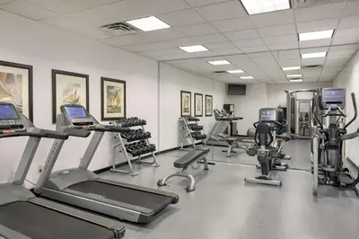 a gym with several treadmills and exercise bikes at Georgian Court Hotel, WorldHotels Elite in Vancouver